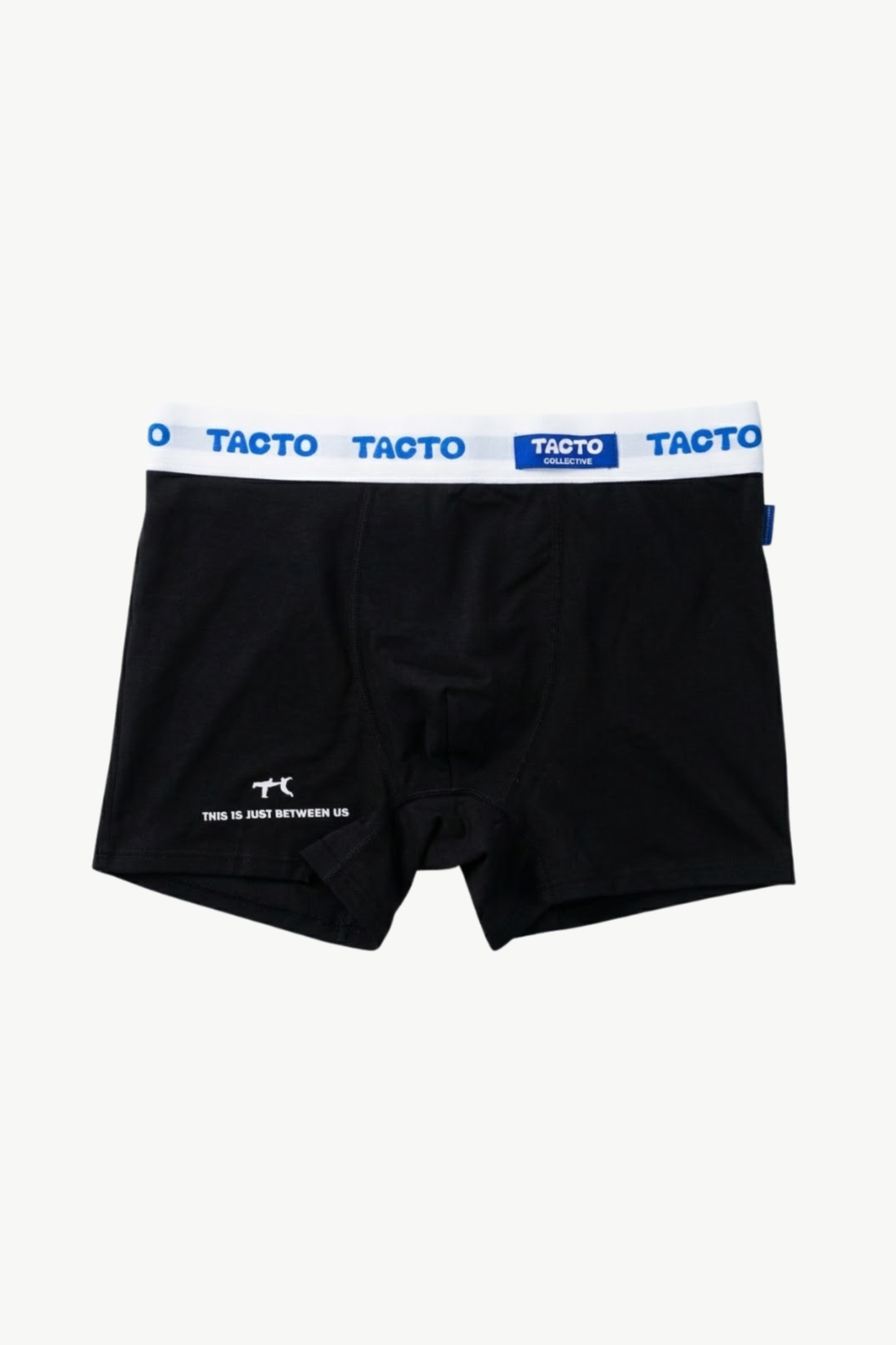 Person wearing black boxer briefs with Tacto waistband on a plain background