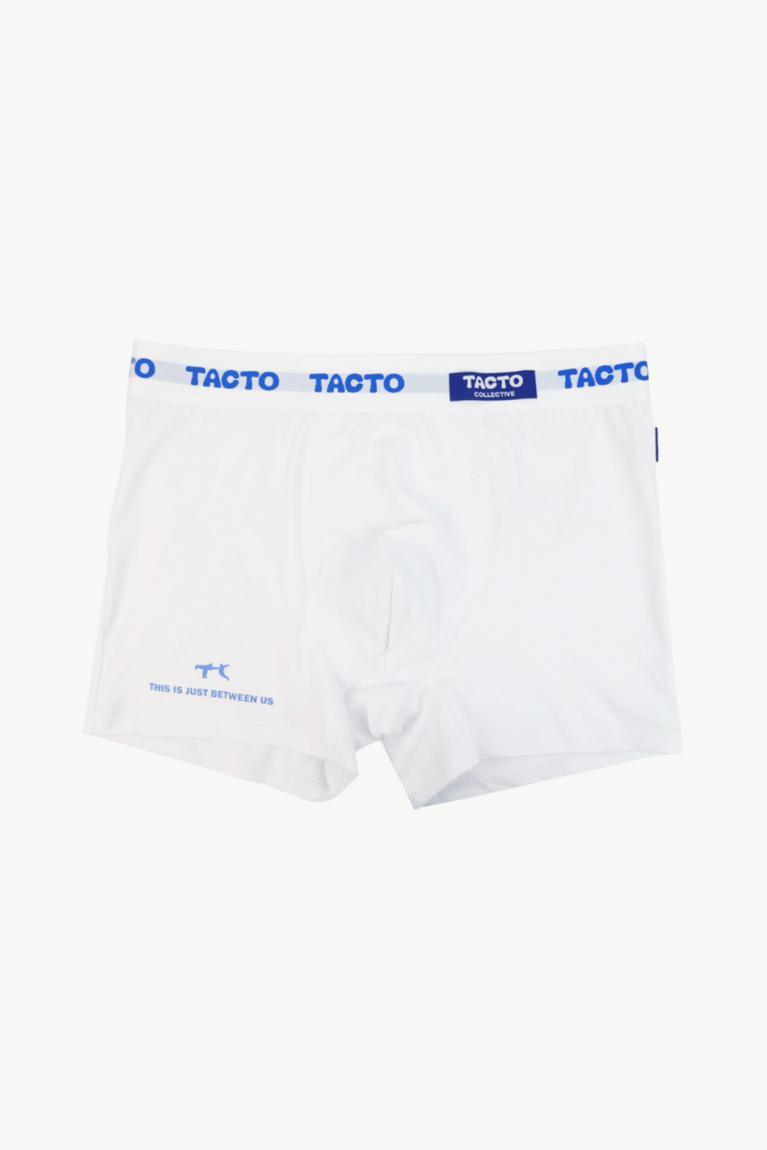 Man wearing white boxer briefs with blue band featuring the brand 'Tacto' on a plain background.