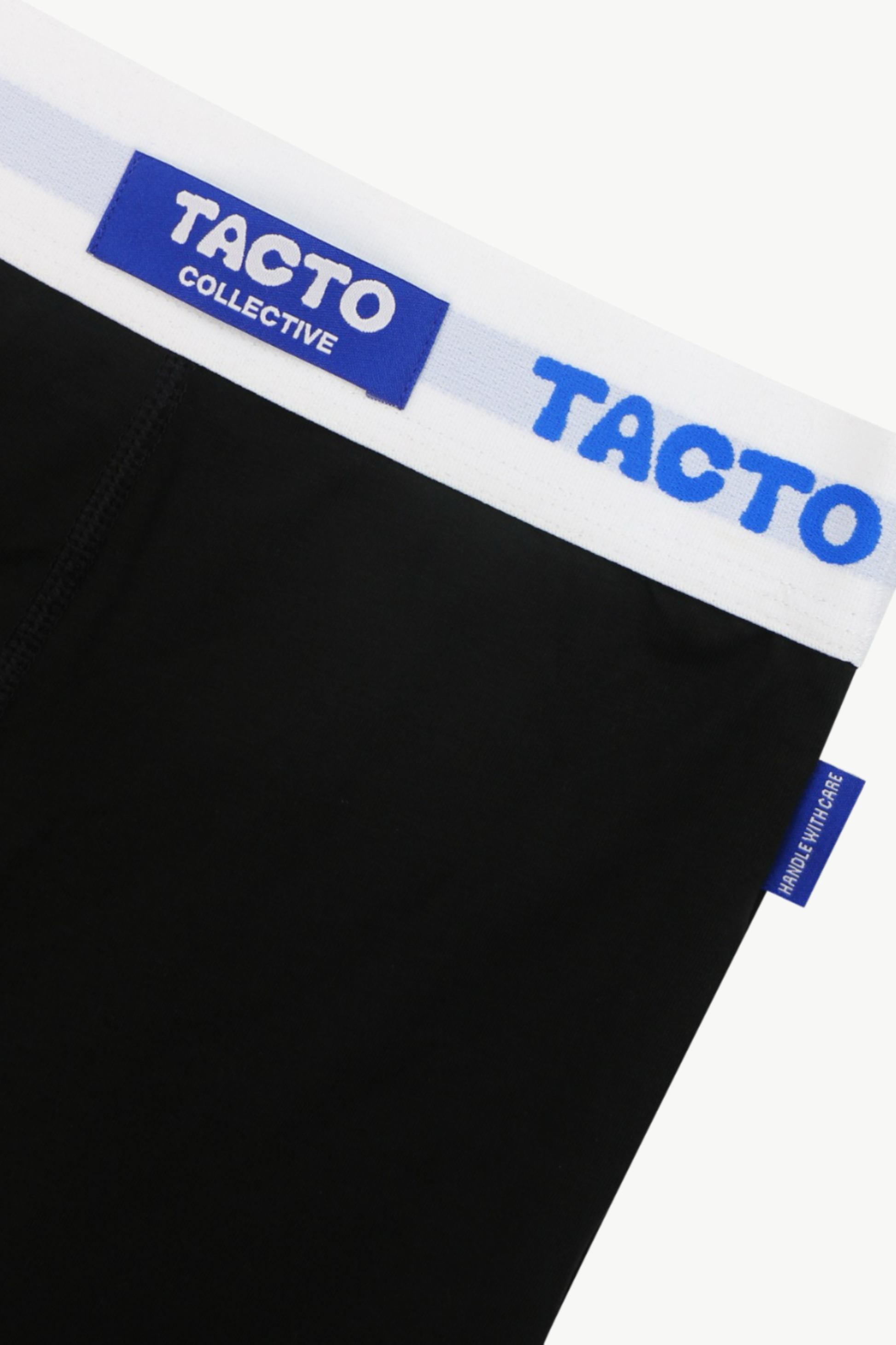 Black boxer briefs with blue and white waistband featuring 'Tacto' branding.