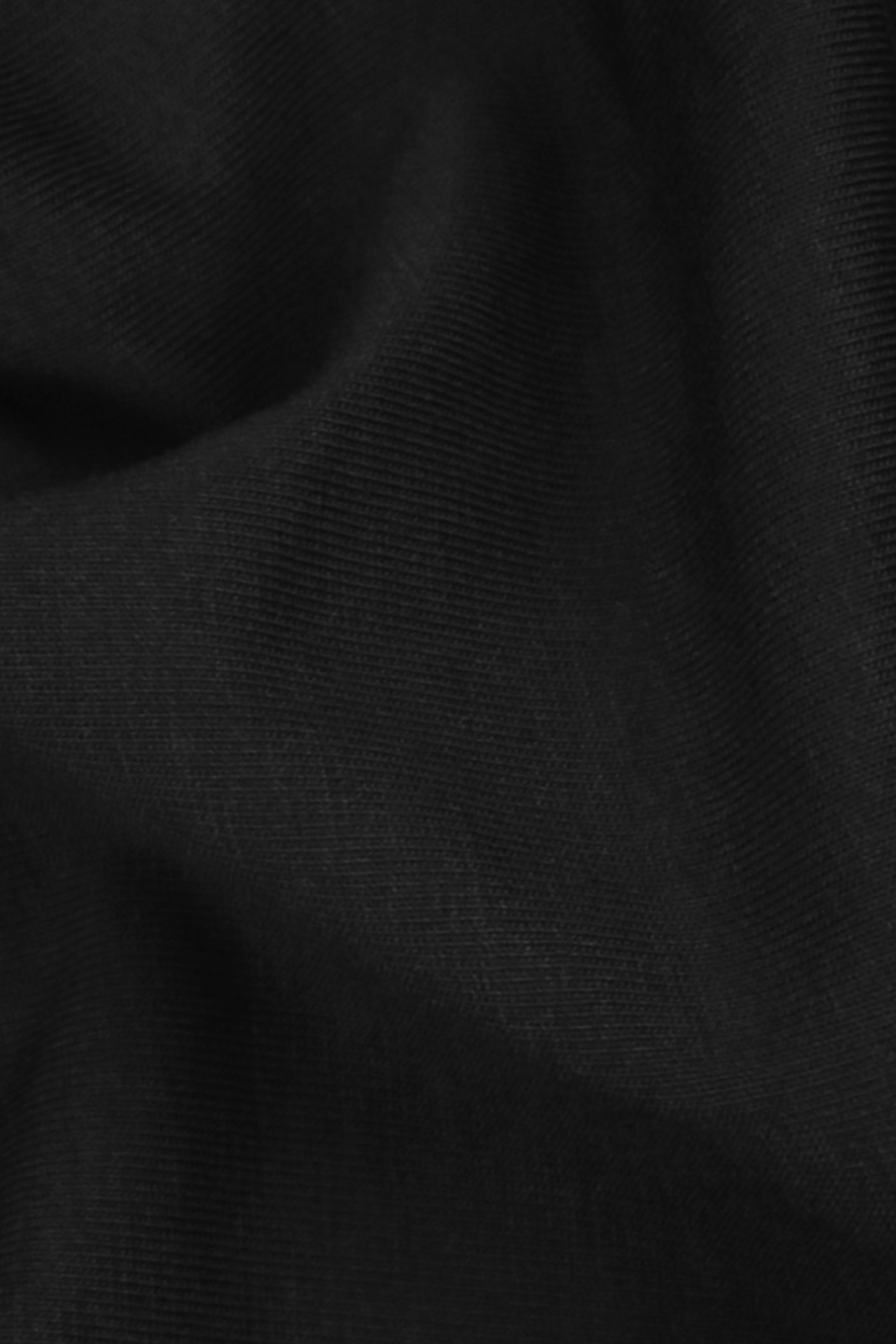 Close-up of black fabric texture. Fabric is organic cotton and modal