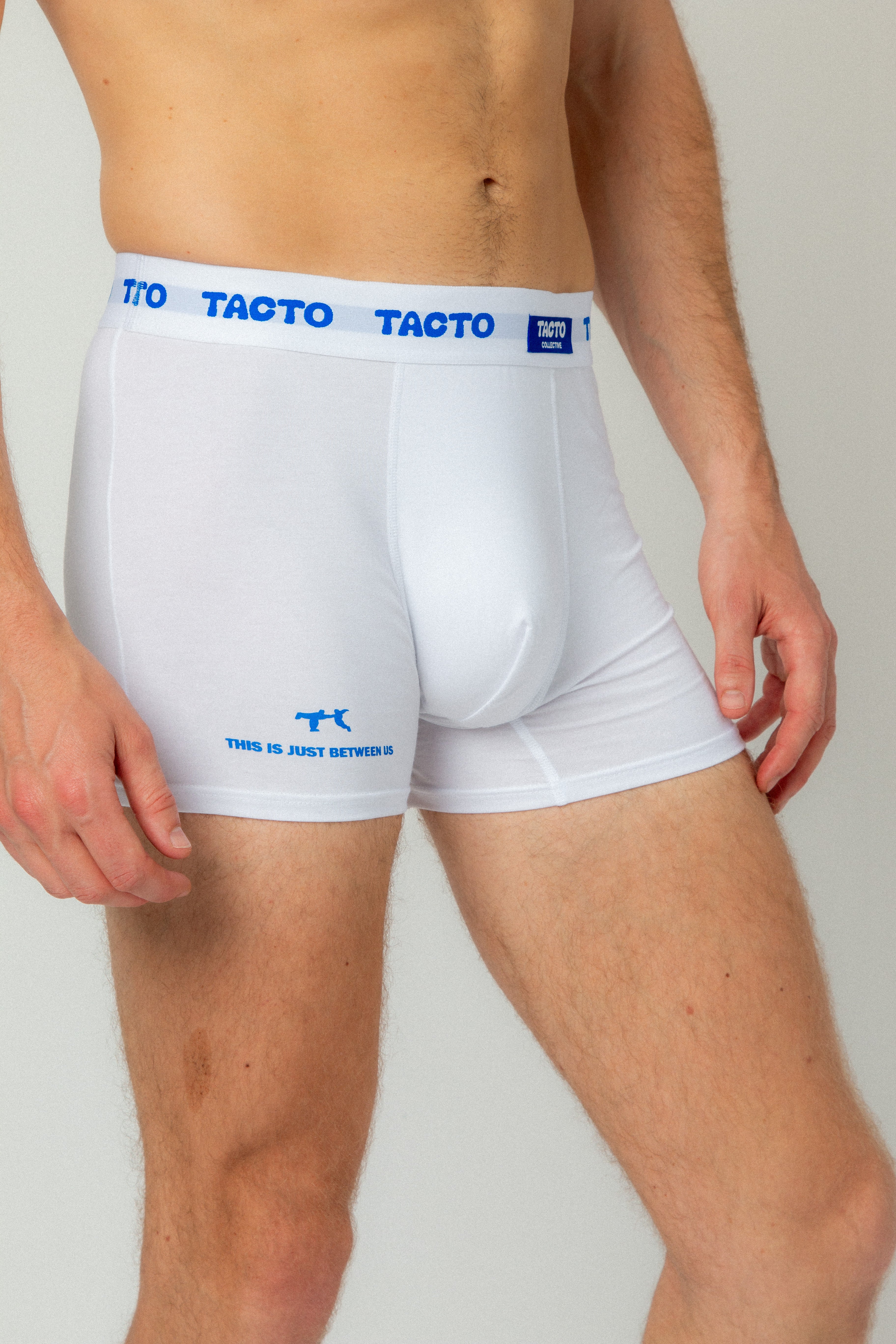 White TACTO boxer briefs with blue waistband and logo on a plain background